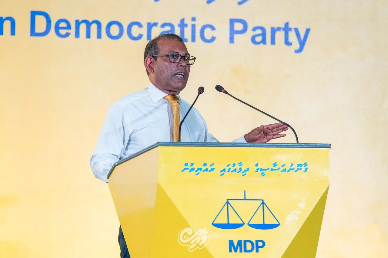 Former President Mohamed Nasheed speaking at a podium with MDP branding